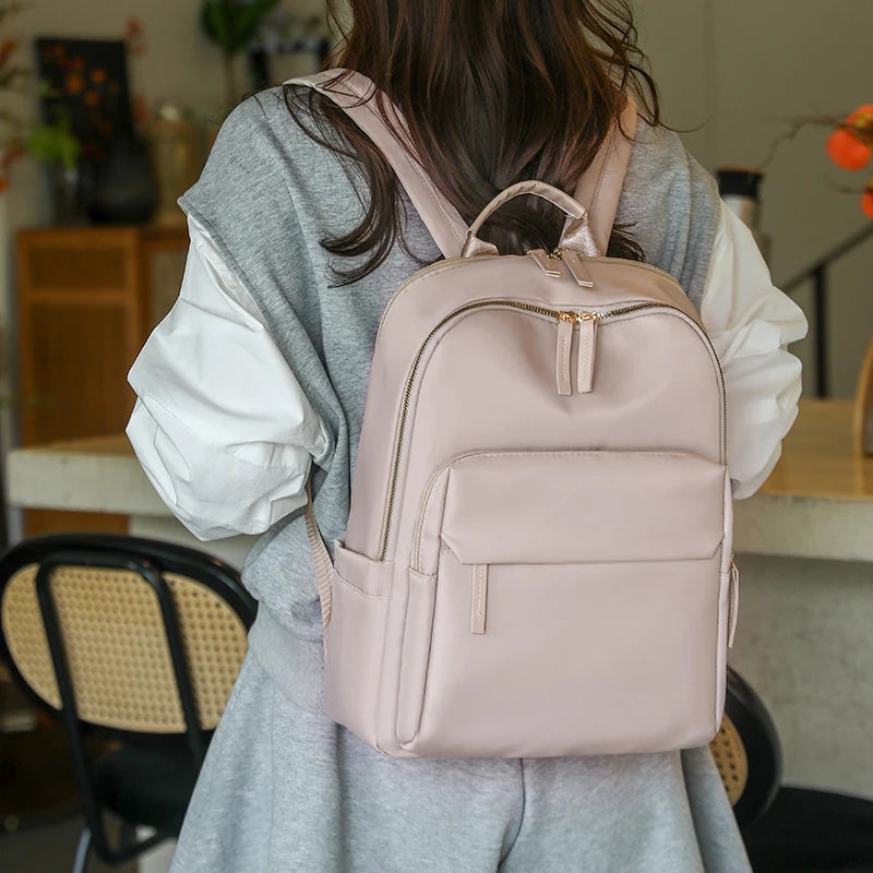 fashion daypack bag showing spacious main pocket filled with school books