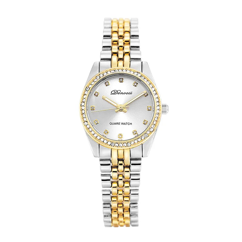 Close up of a luxury quartz watch with a geometric diamond style dial face, minimalist design, and metallic strap.