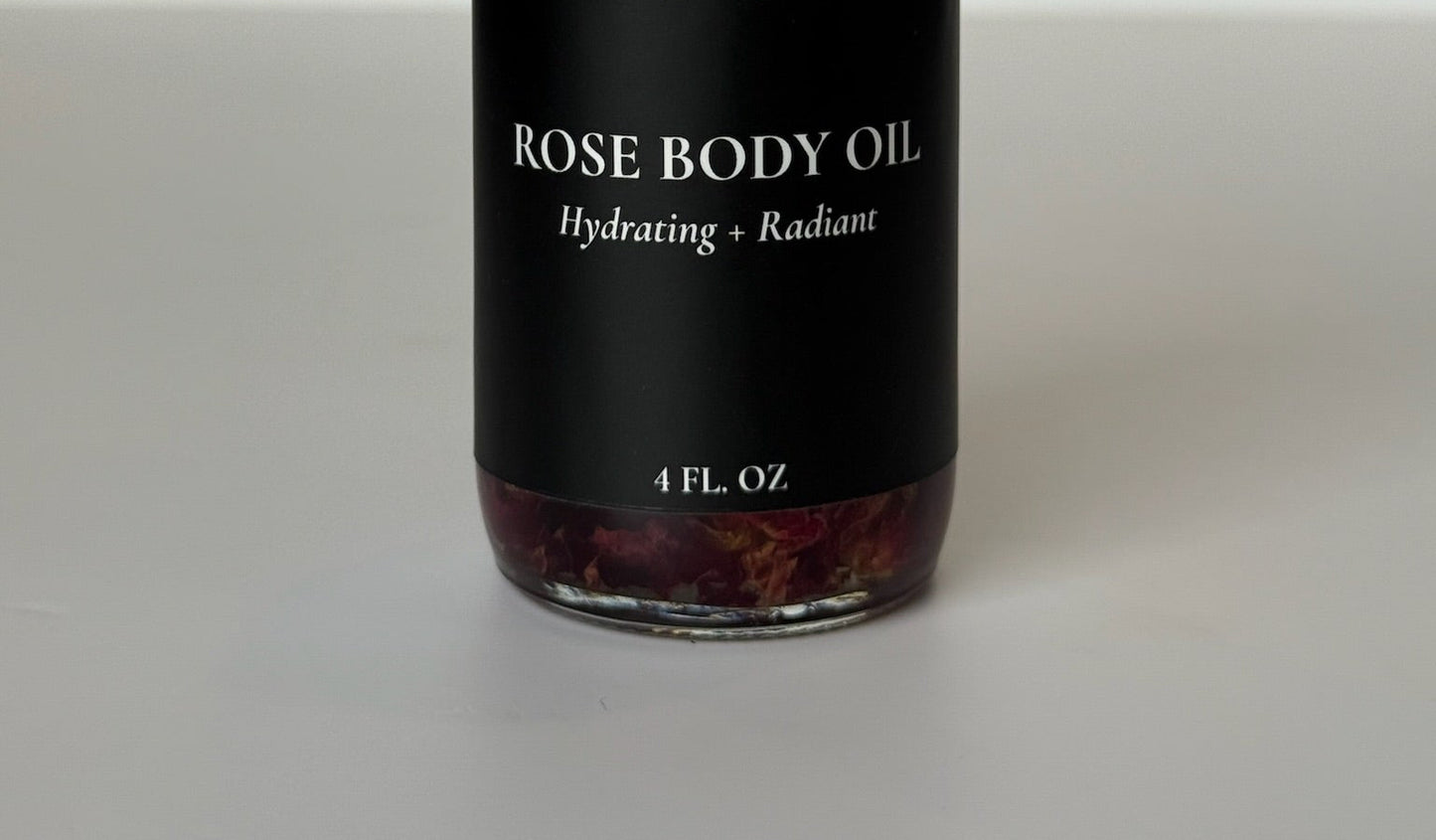 Luxury clear glass bottle of hydrating body oil with real rose petals