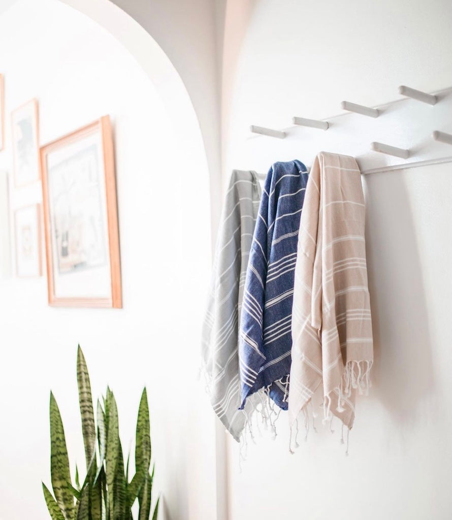 soft traditional Turkish cotton hand towel rolled on spa vanity shelf wine