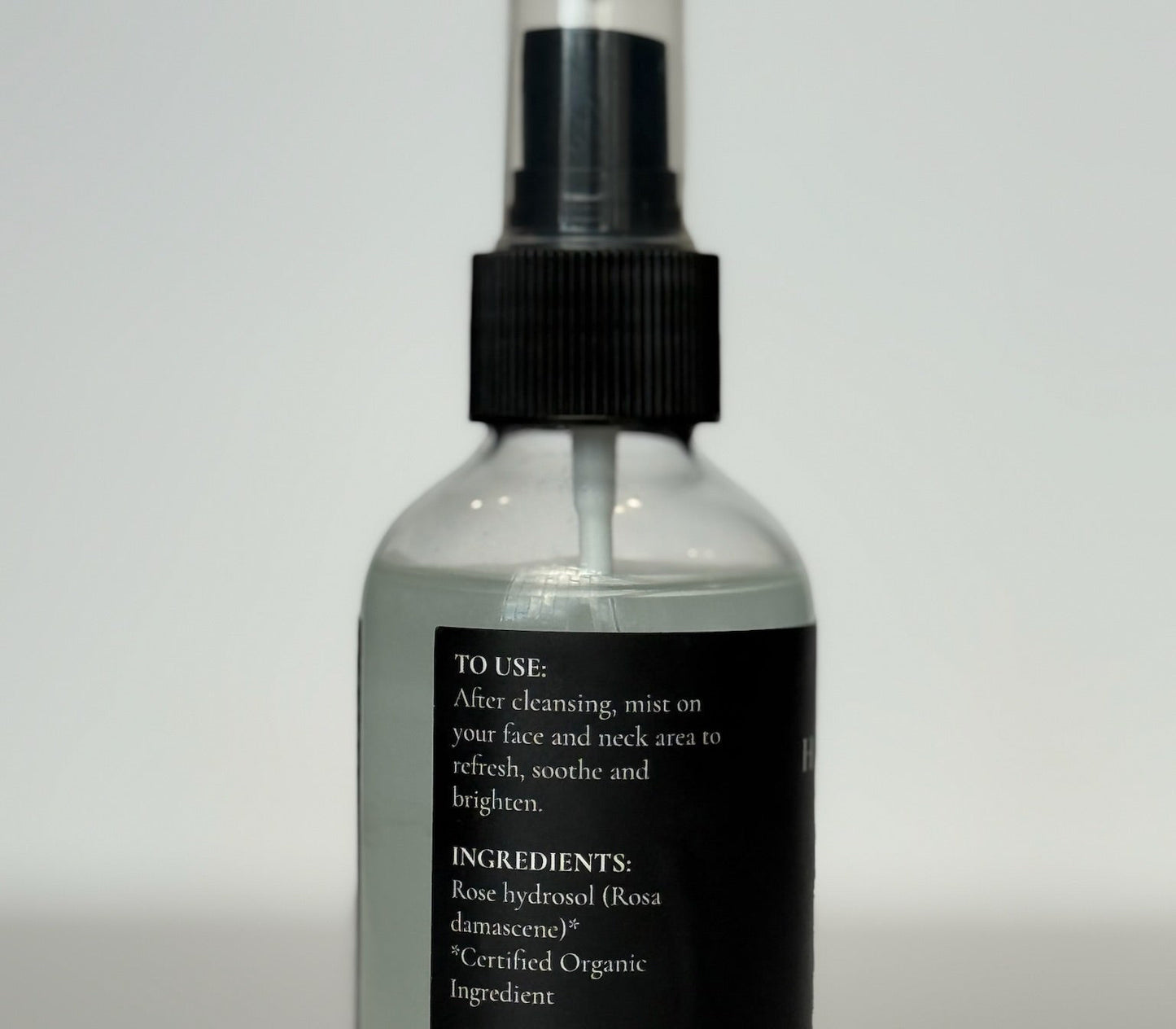 premium clear glass bottle of hydrating organic rose petal face mist cosmetic