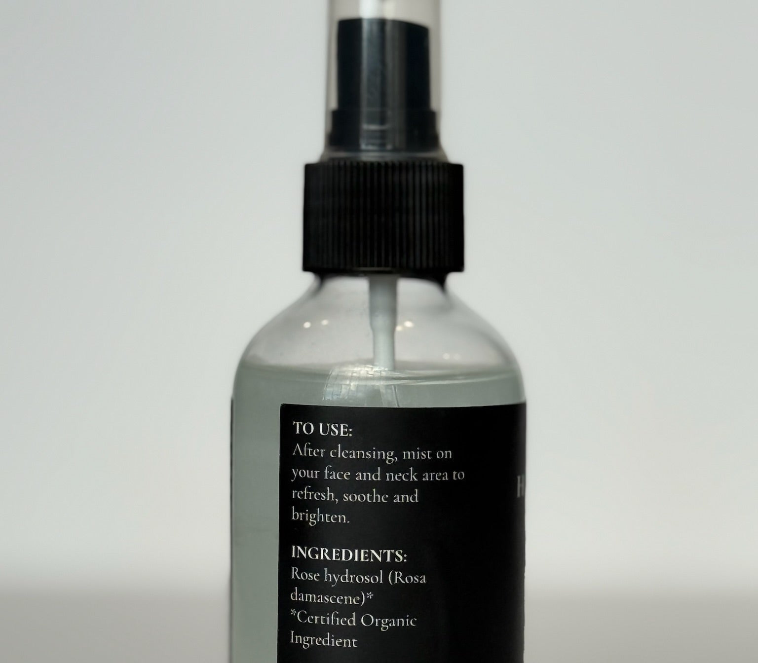 premium clear glass bottle of hydrating organic rose petal face mist cosmetic