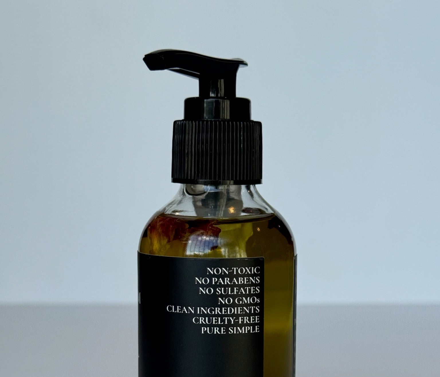 Premium floral infusion body moisturizer oil packaging close up view
