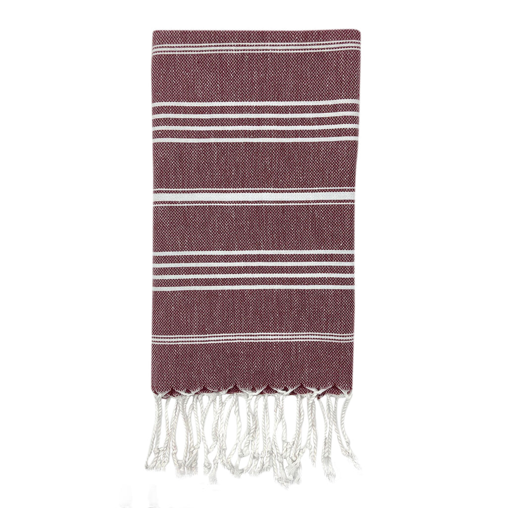 boho style fringed bathroom guest hand towel hanging on wooden peg stripe